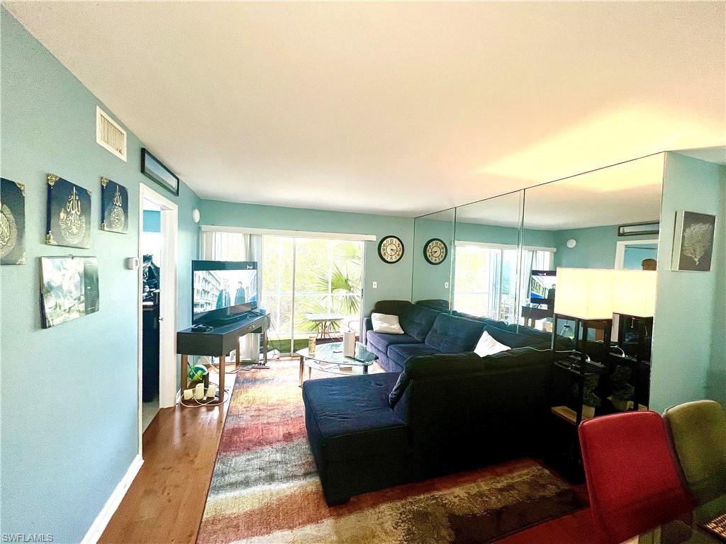 2207 San Marco Road, Unit 4104 Marco Island, FL 34145 - Photo 3 of 21 a living room with furniture and a wooden floor