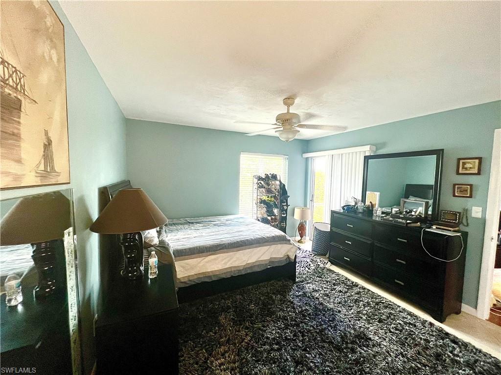 2207 San Marco Road, Unit 4104 Marco Island, FL 34145 - Photo 9 of 21 a bedroom with a bed and a chandelier