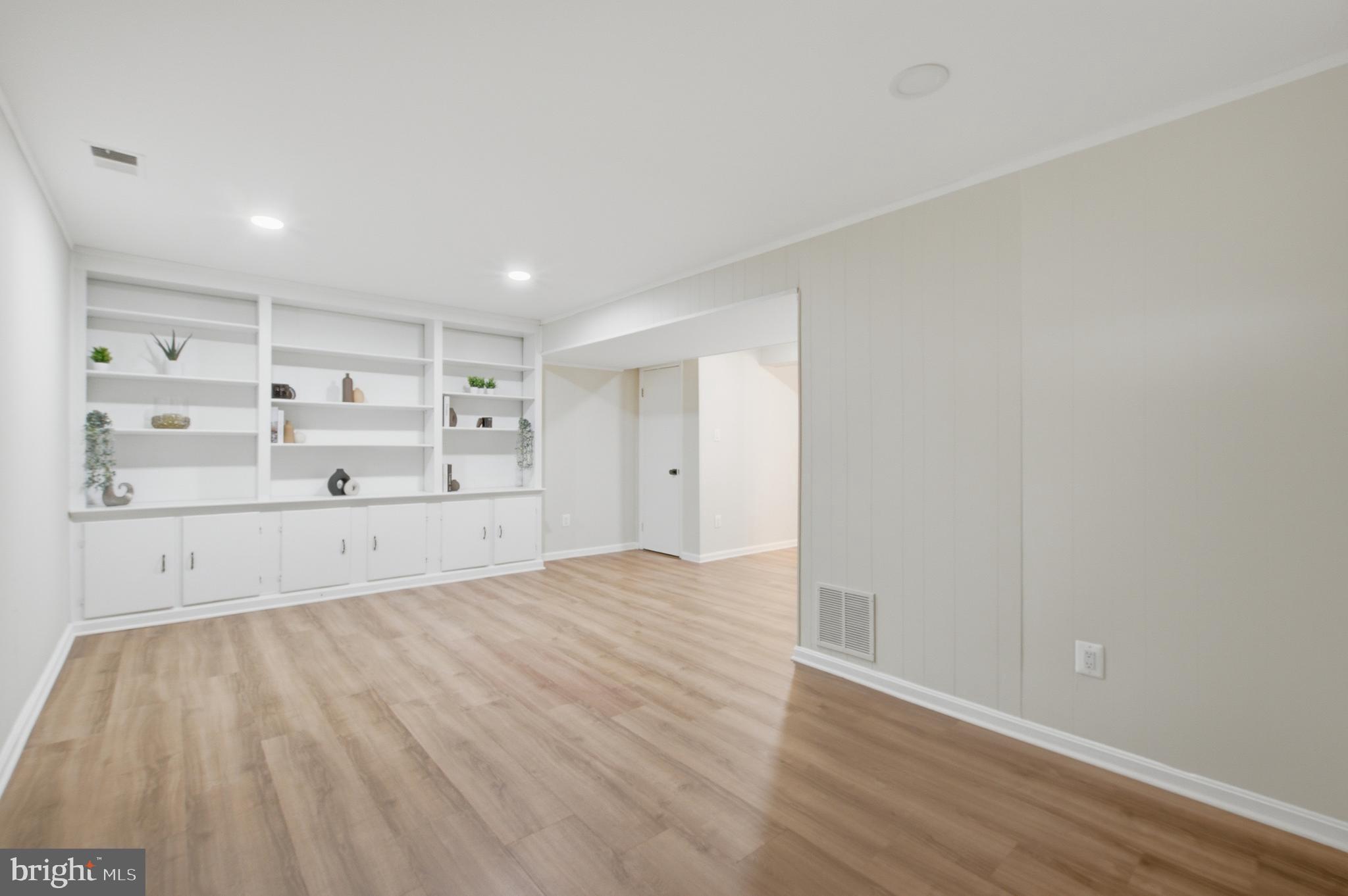 8575 Tyrolean Way Springfield, VA 22153 - Photo 24 of 29 a view of empty room with wooden floor and cabinet