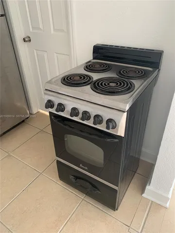 a stove top oven sitting inside of a kitchen