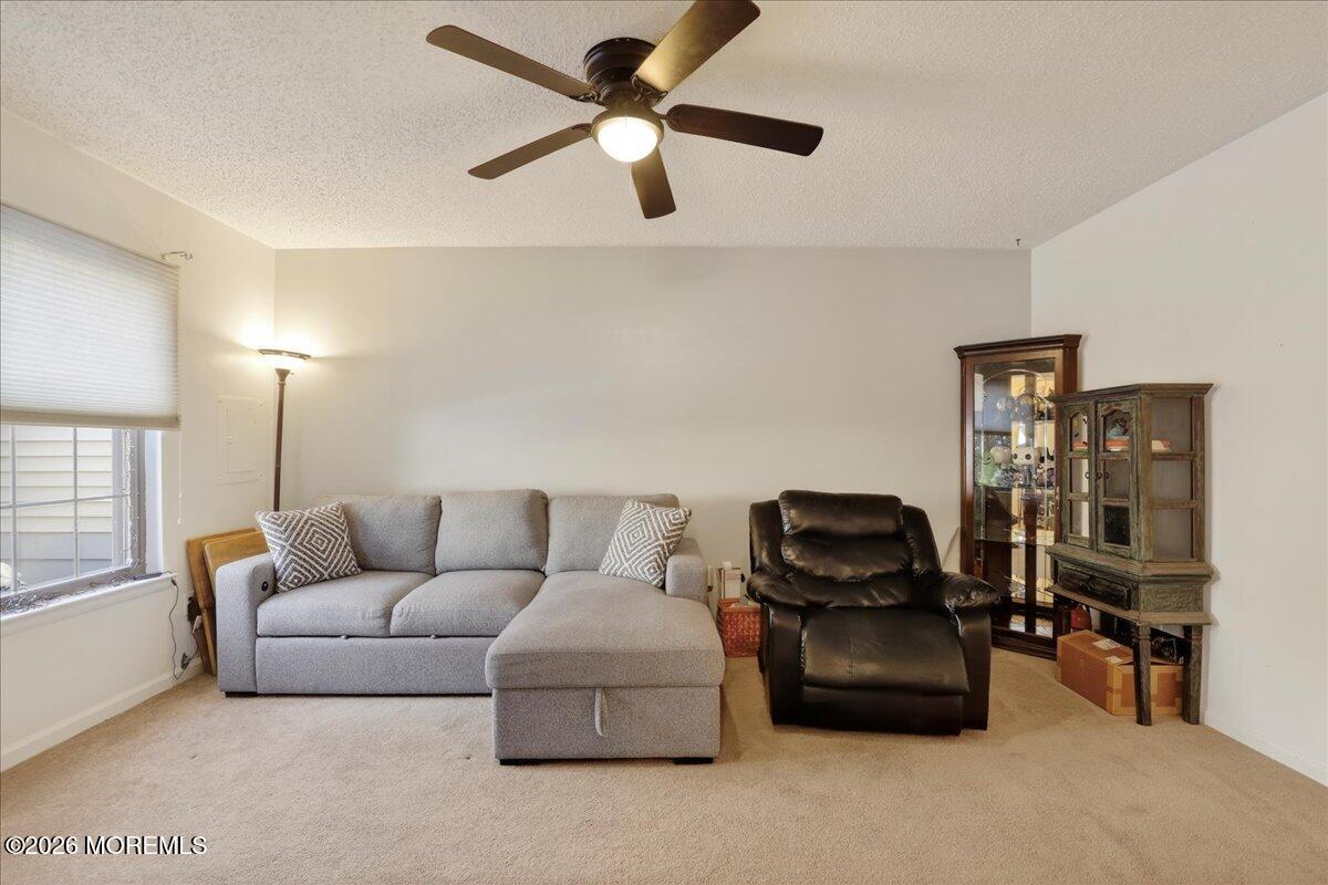 95 Azalea Circle Jackson, NJ 08527 - Photo 24 of 62 a living room with furniture a ceiling fan and a window