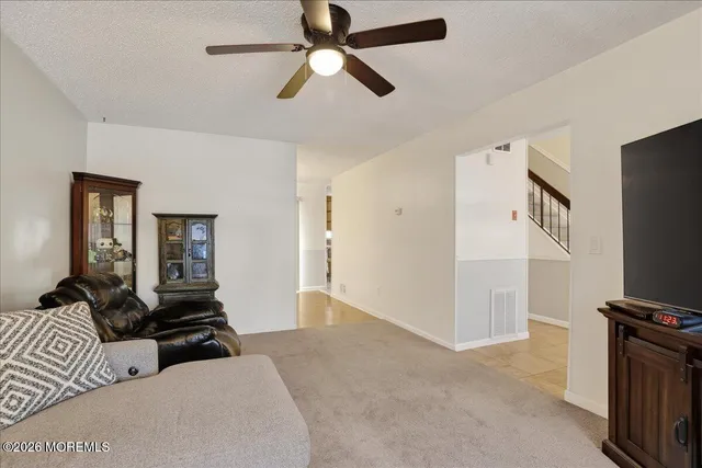 a living room with a bed furniture and a window