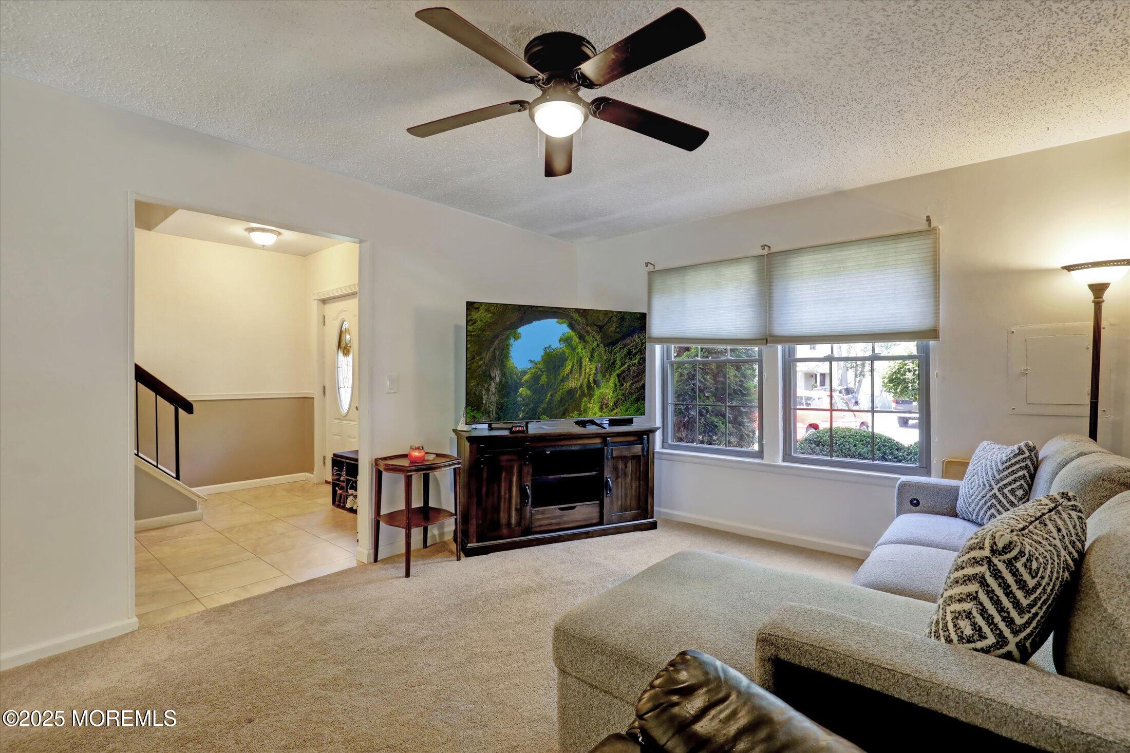 95 Azalea Circle Jackson, NJ 08527 - Photo 27 of 62 a living room with furniture and a flat screen tv