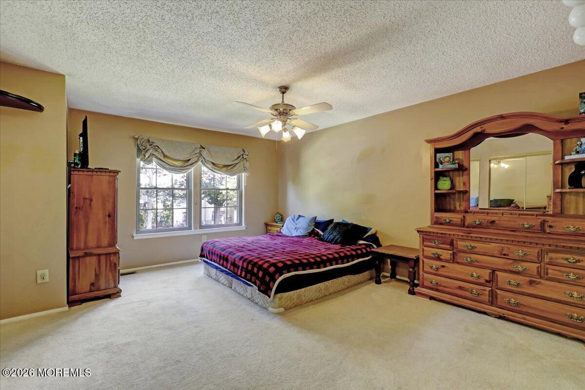 95 Azalea Circle Jackson, NJ 08527 - Photo 33 of 62 a living room with a bed furniture and a window