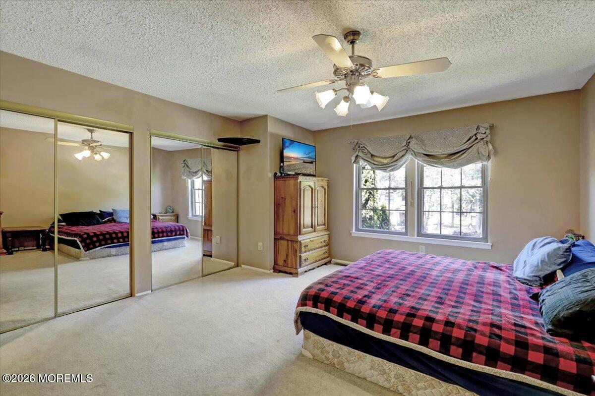 95 Azalea Circle Jackson, NJ 08527 - Photo 34 of 62 a bedroom with a bed and a chandelier