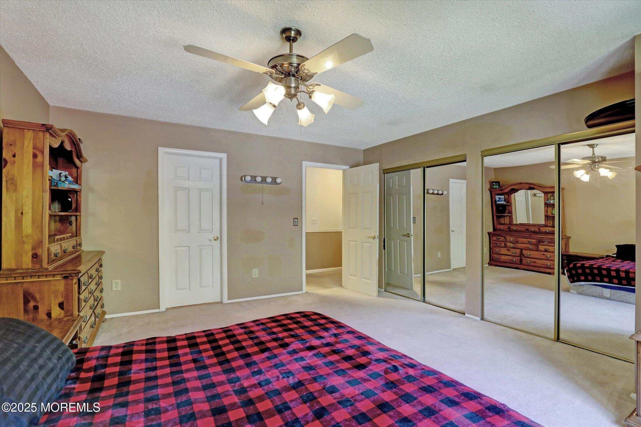 95 Azalea Circle Jackson, NJ 08527 - Photo 37 of 62 a bedroom with a bed and a chandelier