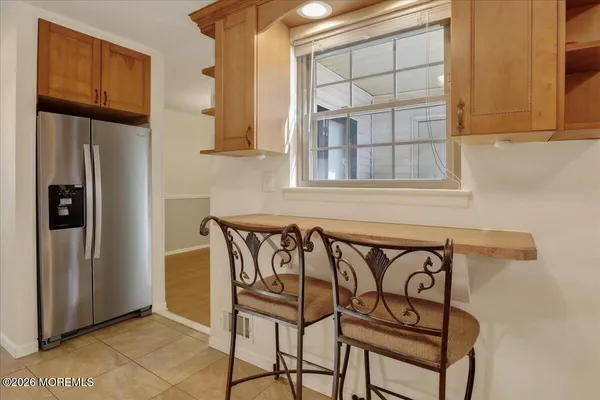 a view of a door and chair in the kitchen