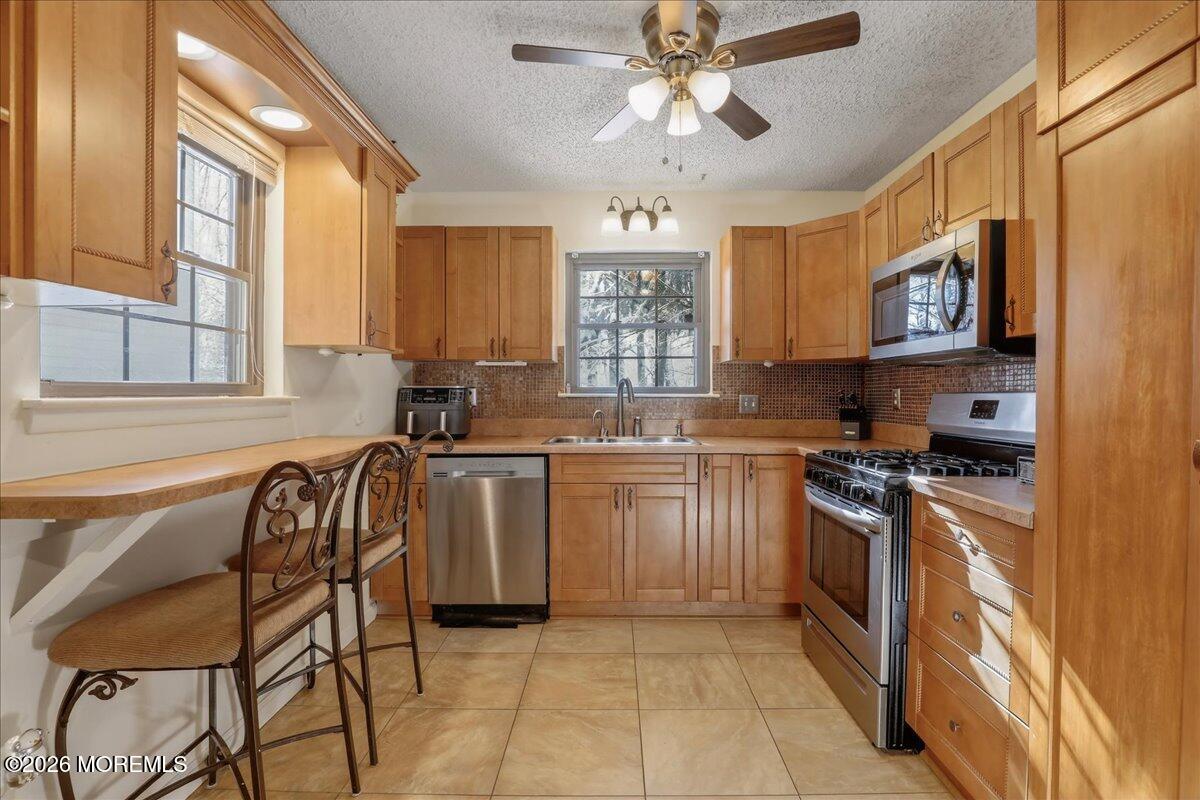 95 Azalea Circle Jackson, NJ 08527 - Photo 8 of 62 a kitchen with stainless steel appliances granite countertop a stove a sink and a refrigerator