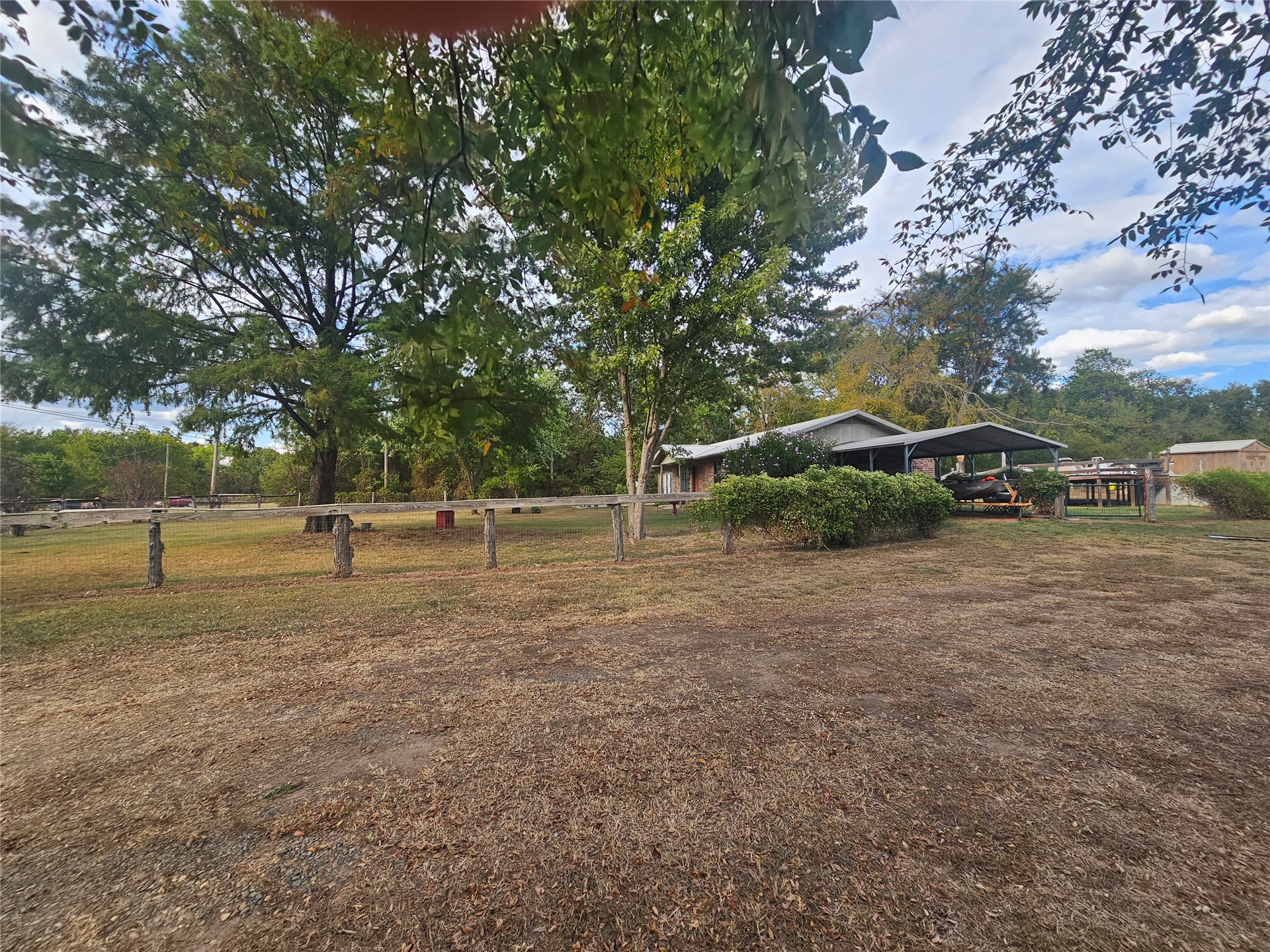 106441 South 4163rd Road Checotah, OK 74426 - Photo 3 of 17 dog runs fenced yard and pasture. property featuring mature trees and a detached carport an shop