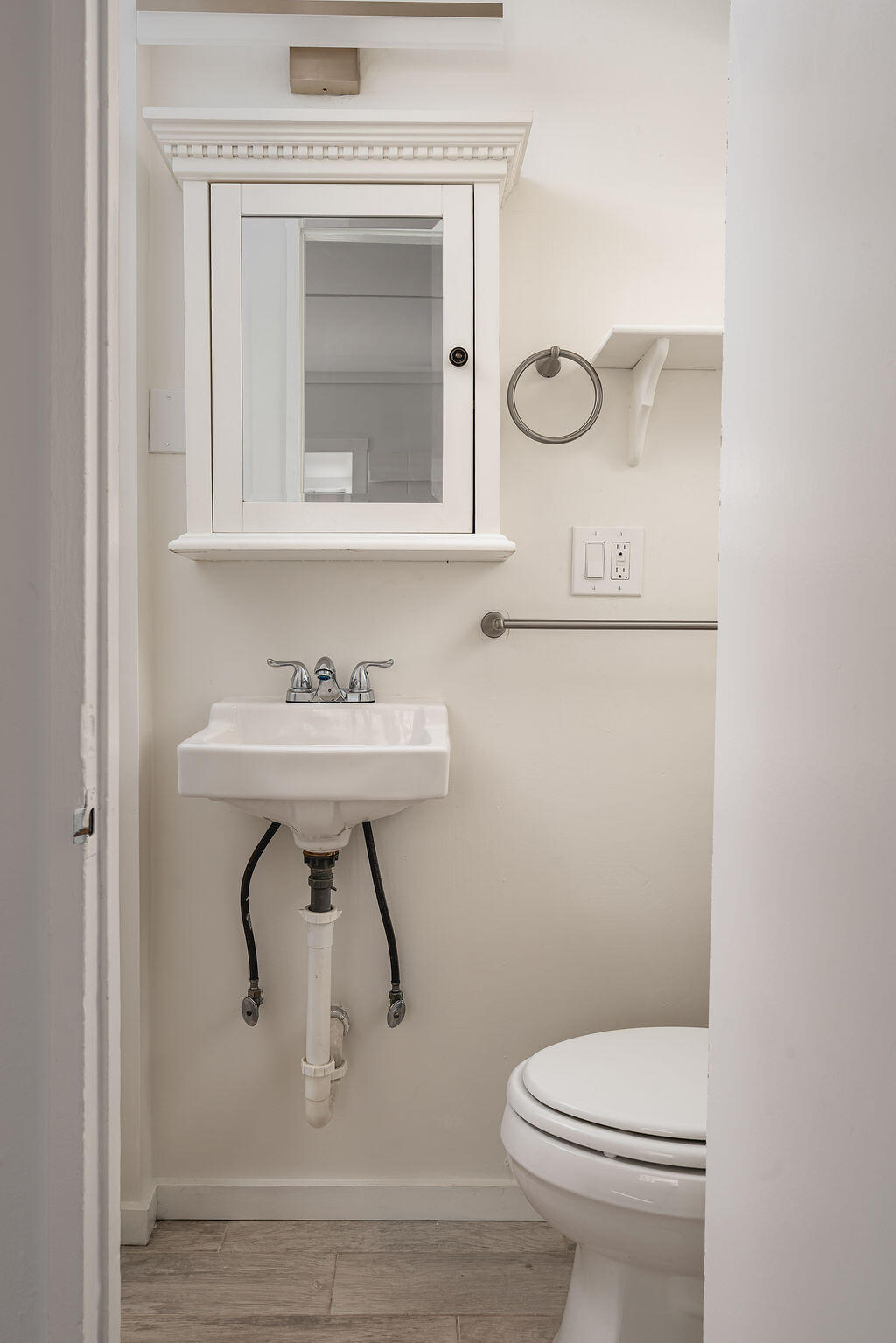 2605 Bath Street Santa Barbara, CA 93105 - Photo 19 of 20 a bathroom with a toilet a sink and mirror