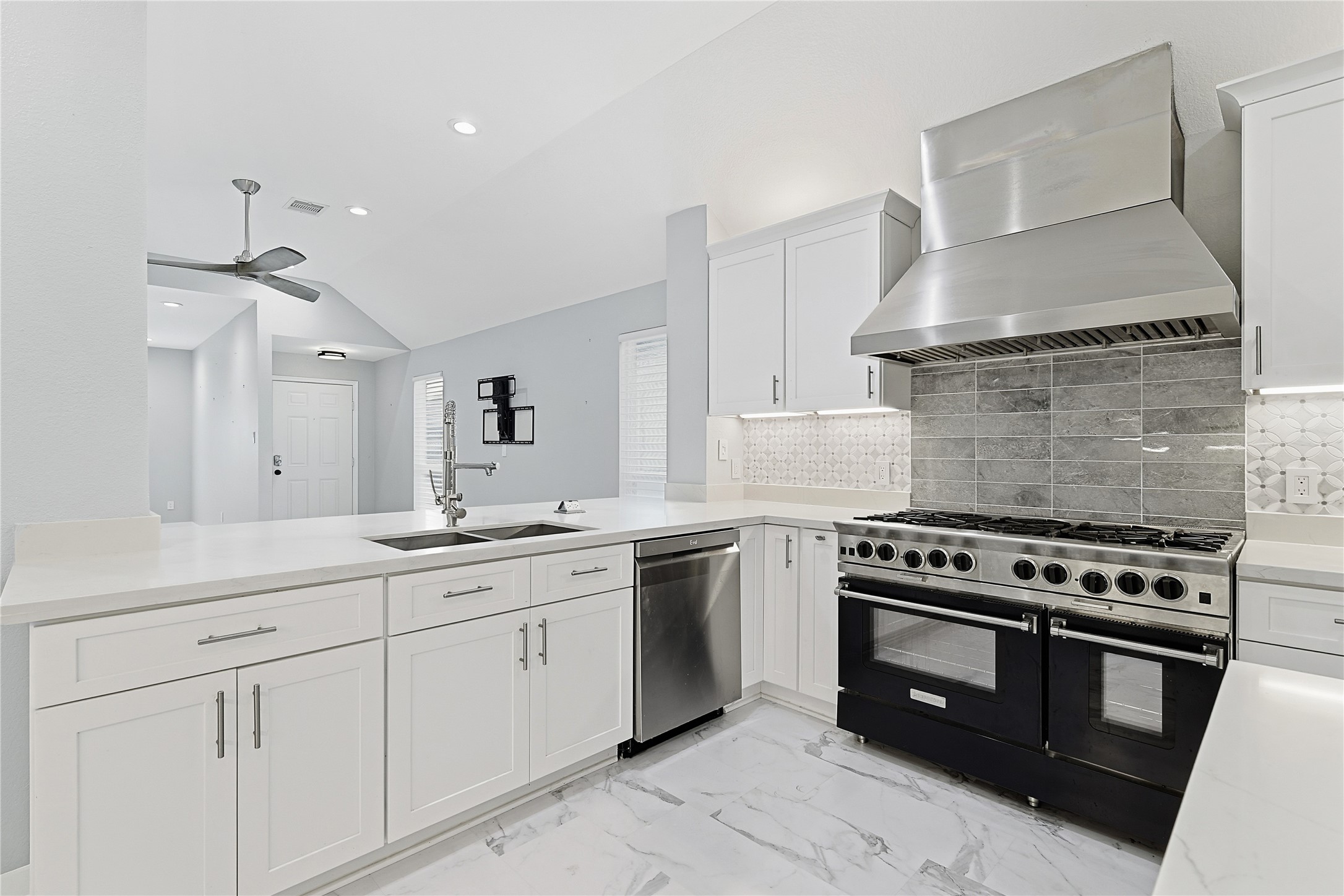 962 Oak Falls Drive Conroe, TX 77378 - Photo 12 of 28 a kitchen with white cabinets and appliances