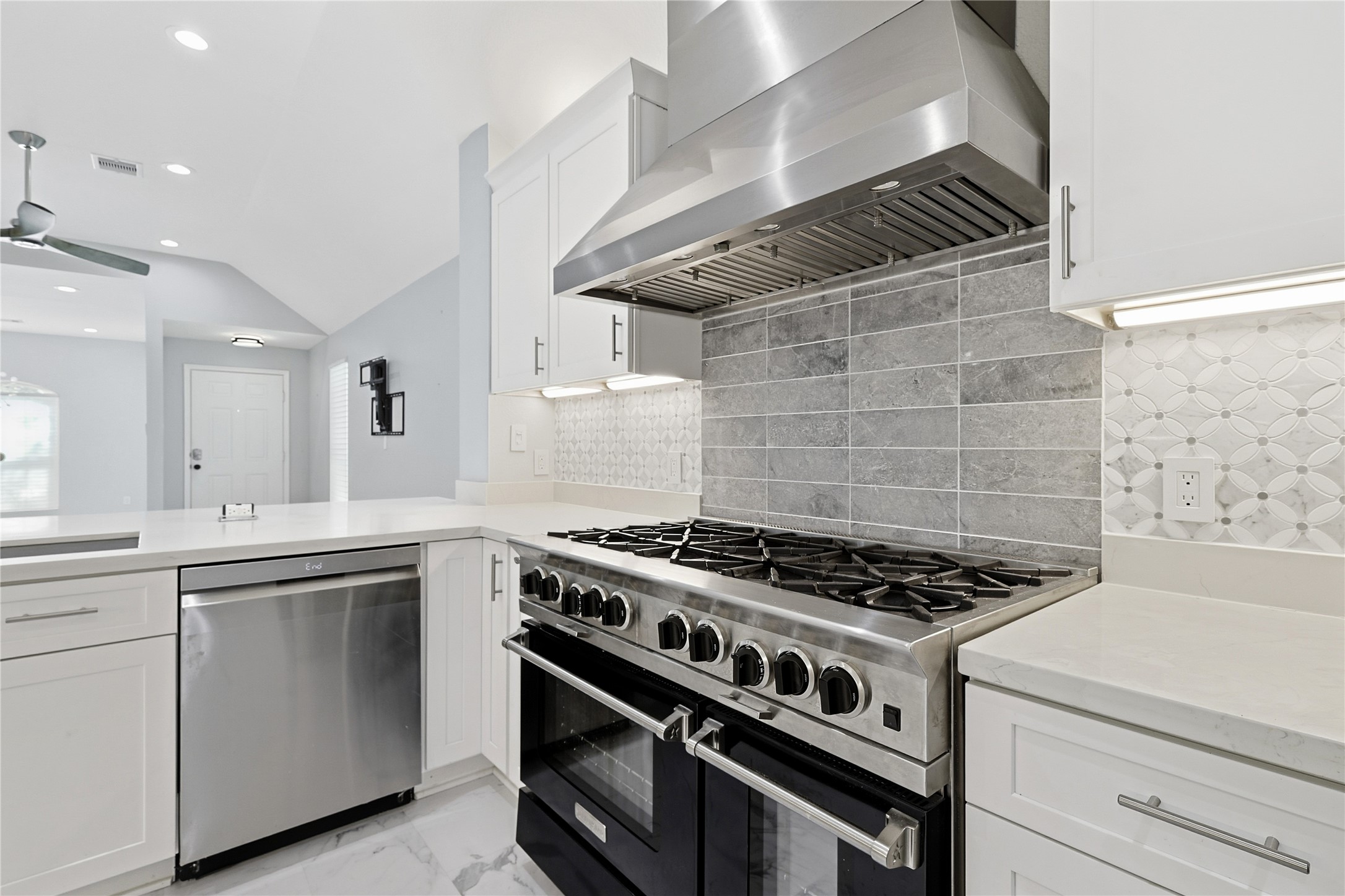 962 Oak Falls Drive Conroe, TX 77378 - Photo 13 of 28 a kitchen with white cabinets and appliances