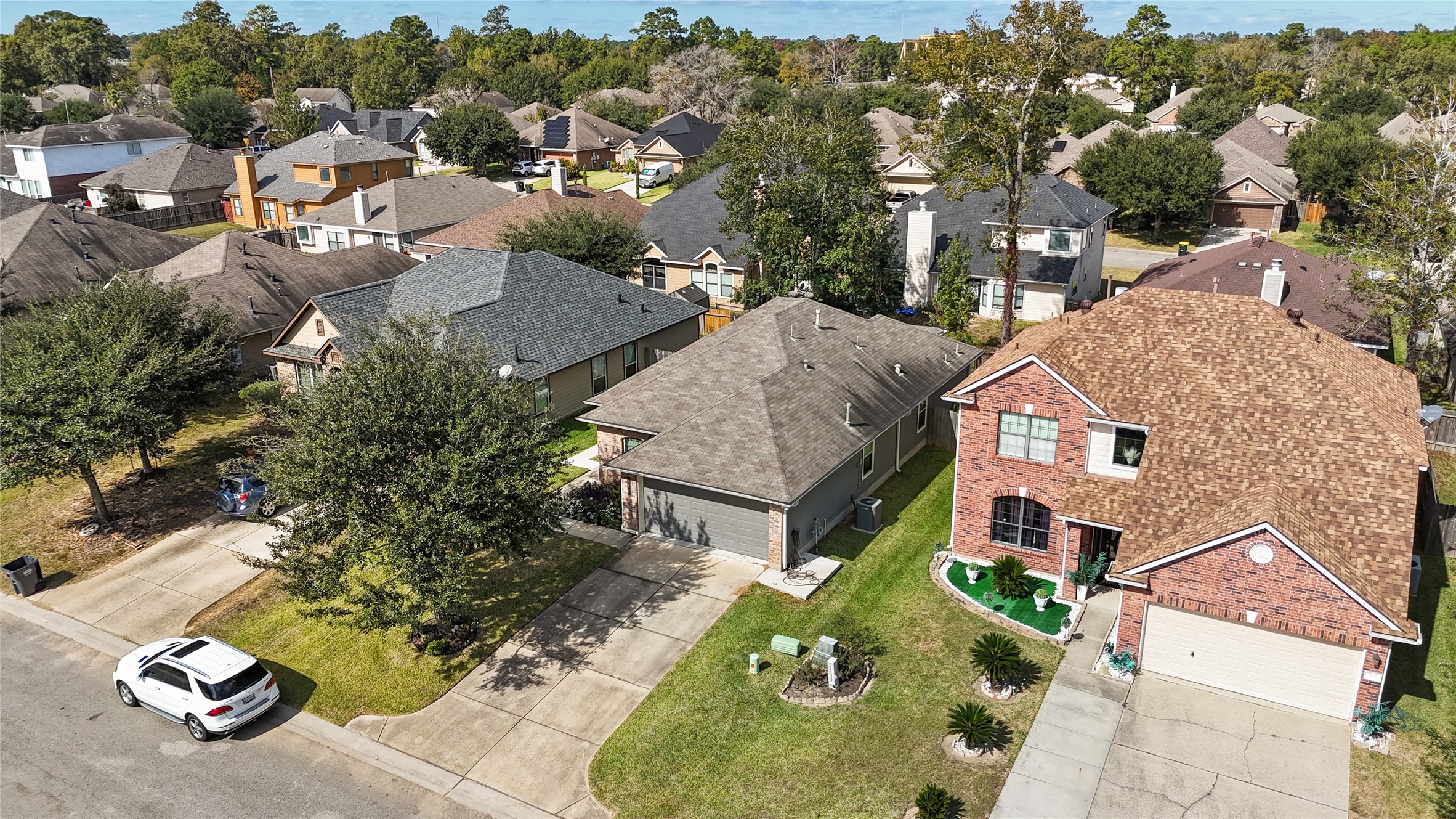 962 Oak Falls Drive Conroe, TX 77378 - Photo 22 of 28 an aerial view of a house with a yard and lake view