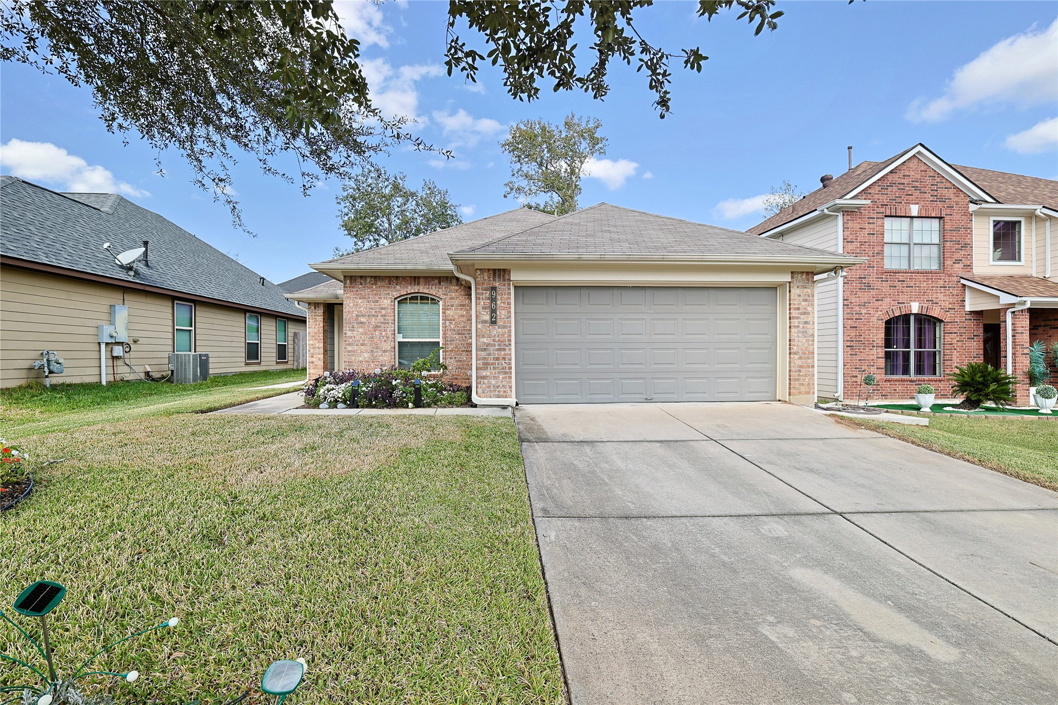 962 Oak Falls Drive Conroe, TX 77378 - Photo 6 of 28 a front view of a house with a yard and garage