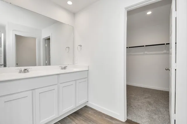a bathroom with a double vanity sink and mirror