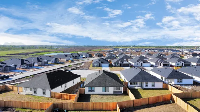 an aerial view of residential houses with outdoor space