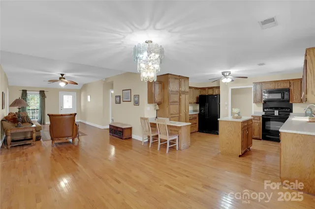 a kitchen with granite countertop a refrigerator stove top oven and sink