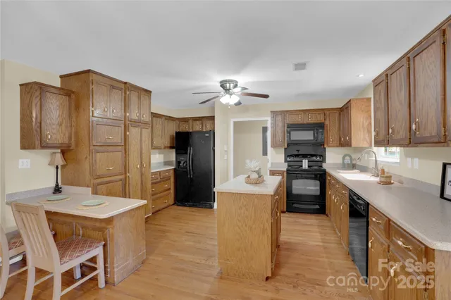 a kitchen with a sink appliances and cabinets