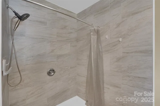 a view of a livingroom with a ceiling fan and window