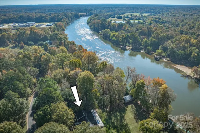 an aerial view of a house with a lake view