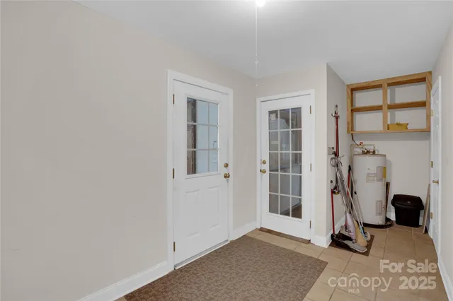 an empty room with closet and a chandelier fan