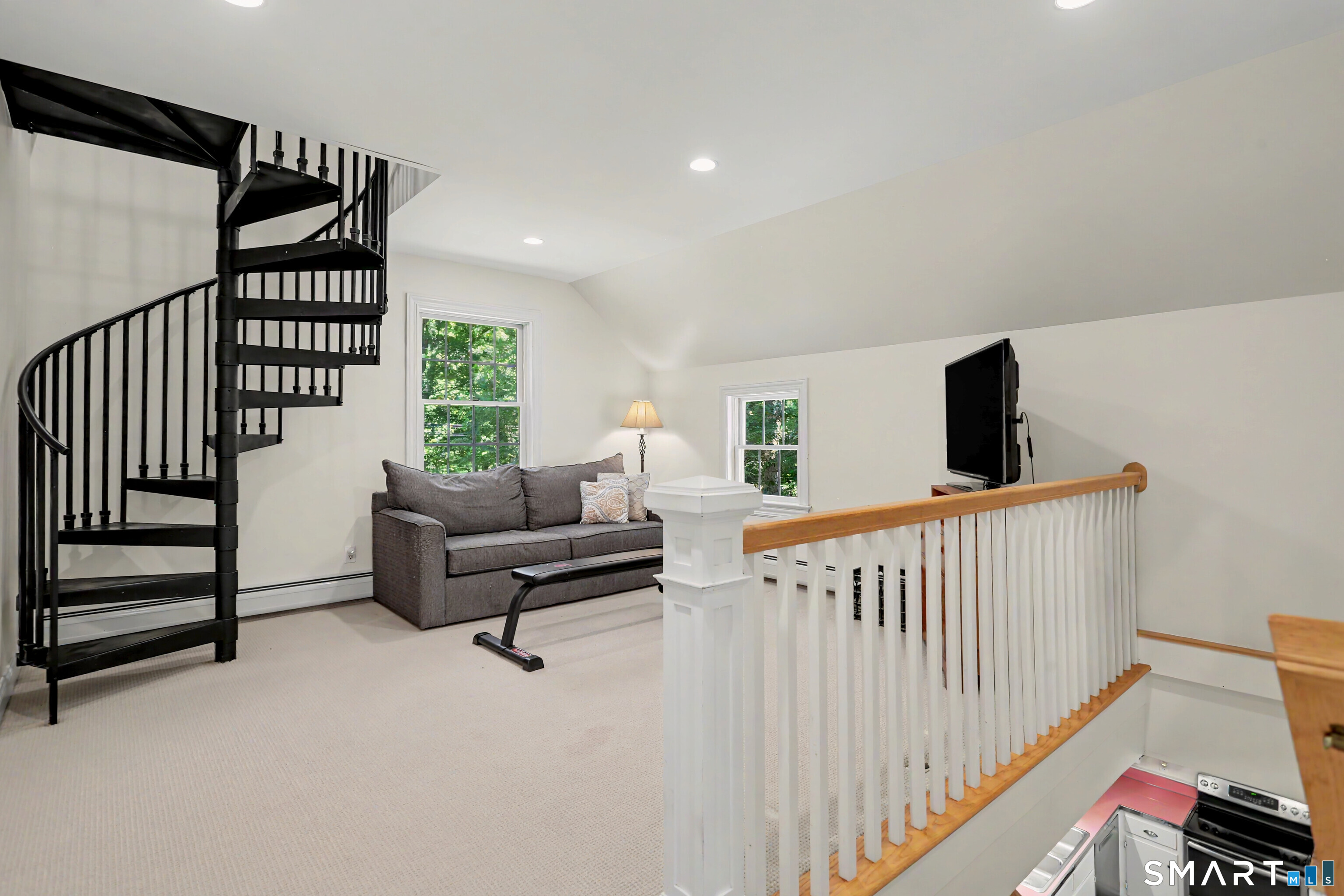 31 Vista Road Wilton, CT 06897 - Photo 23 of 34 Bright second-floor den featuring a dramatic spiral staircase leading to a versatile loft space.