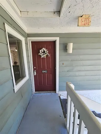 a view of a hallway with wooden floor and stairs