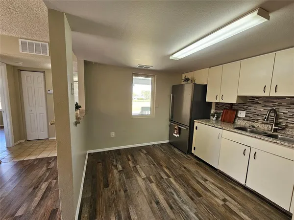 a garden with trees in front of it