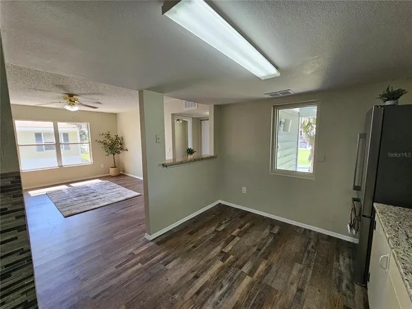 a view of a house with a tree next to a yard