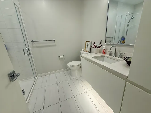 a bathroom with a sink a toilet and a mirror