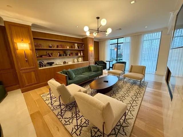 a living room with furniture a chandelier and a dining table