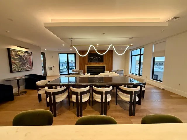 a living room with furniture a rug and a large window