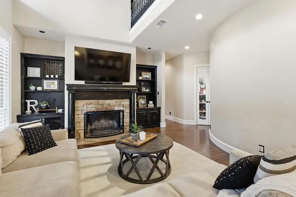 a living room with furniture a flat screen tv and a fireplace