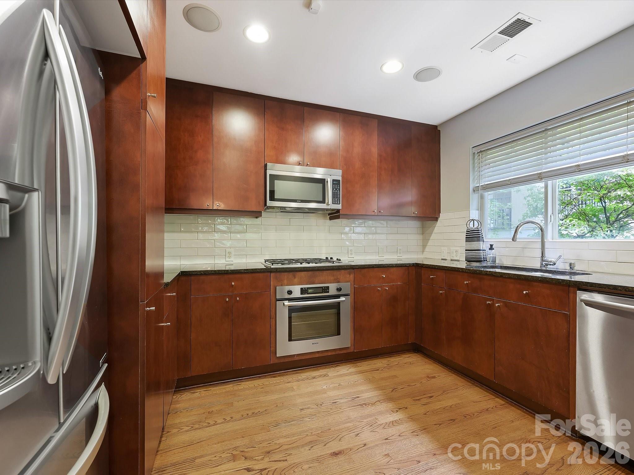 420 Queens Road Charlotte, NC 28207 - Photo 15 of 35 a kitchen with stainless steel appliances granite countertop a refrigerator sink and stove