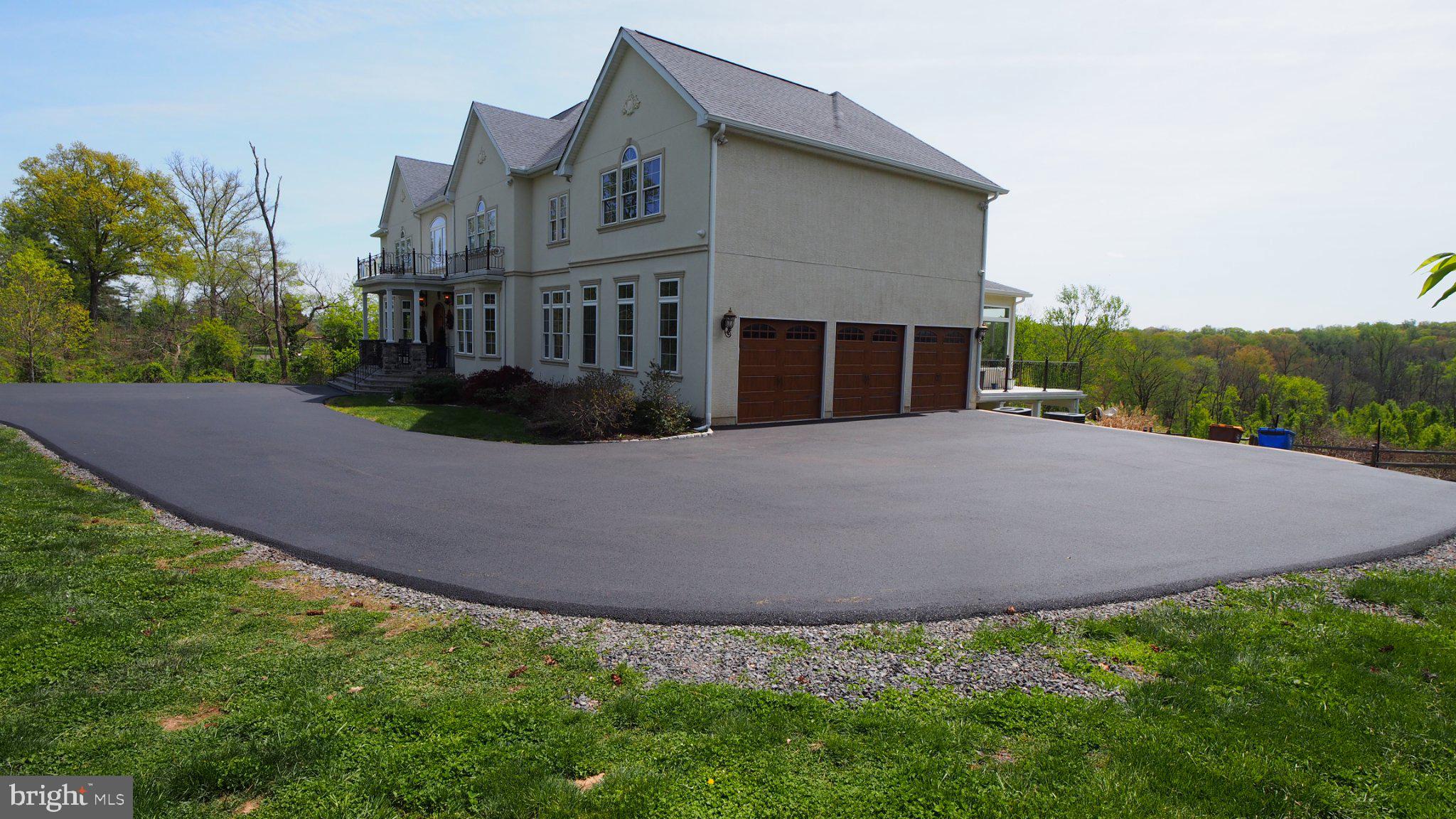 Elegant home with expansive driveway.