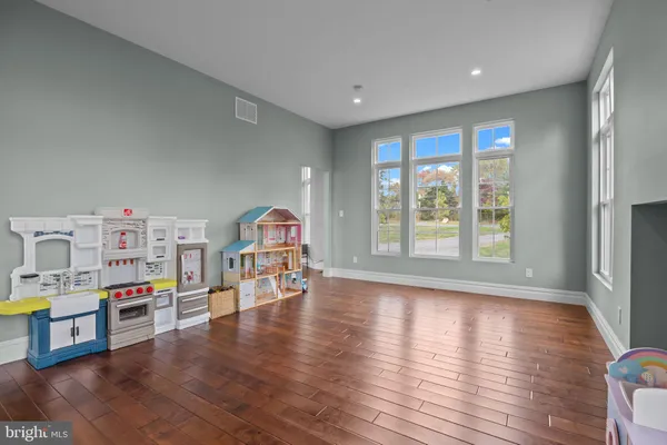 a kitchen with stainless steel appliances granite countertop a stove and wooden cabinets with wooden floors