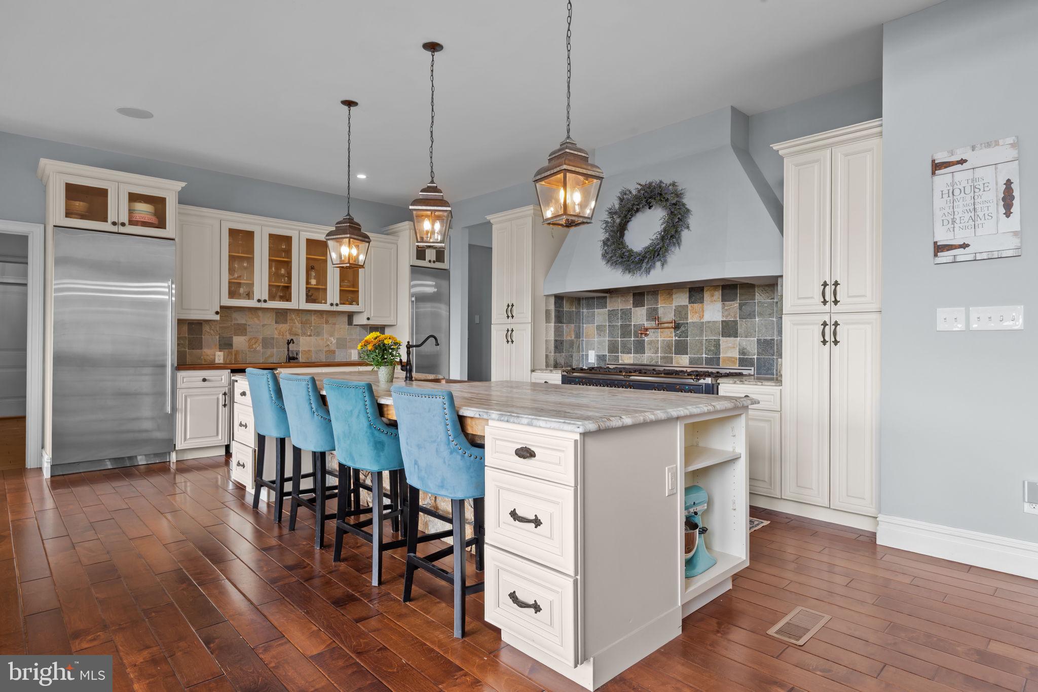274 Pineville Road Newtown, PA 18940 - Photo 23 of 108 a kitchen with stainless steel appliances granite countertop a stove a refrigerator and a wooden floor
