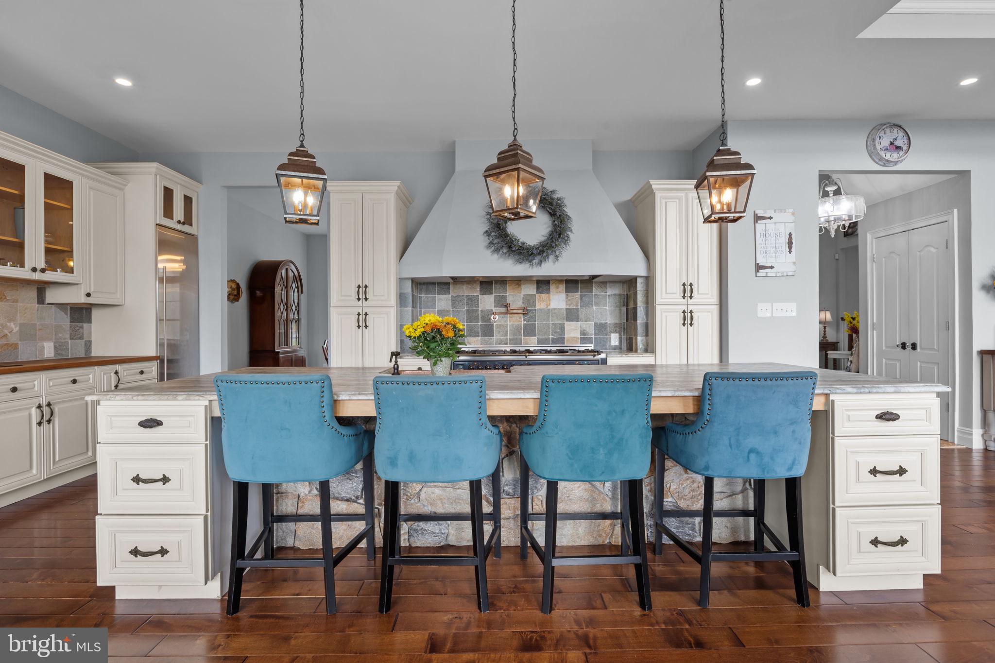 274 Pineville Road Newtown, PA 18940 - Photo 24 of 108 a kitchen with stainless steel appliances granite countertop a table chairs and a refrigerator