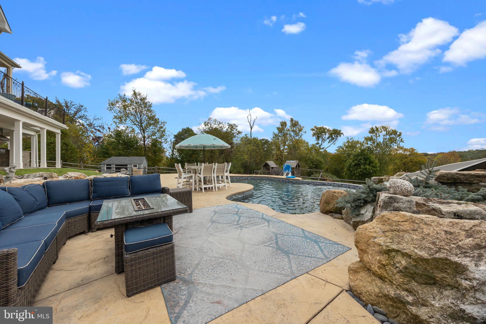 274 Pineville Road Newtown, PA 18940 - Photo 84 of 108 a view of a swimming pool with couches and wooden floor