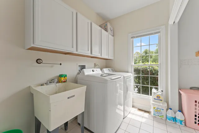 a living room with furniture chandelier and a window