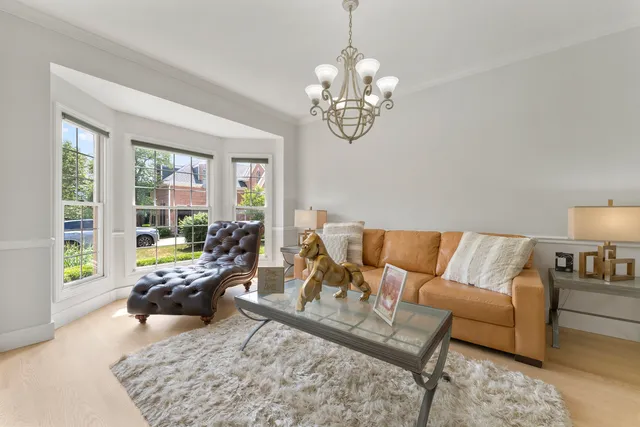 a living room with furniture and a chandelier
