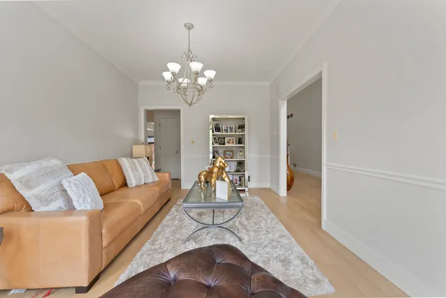 a workspace with furniture a chandelier