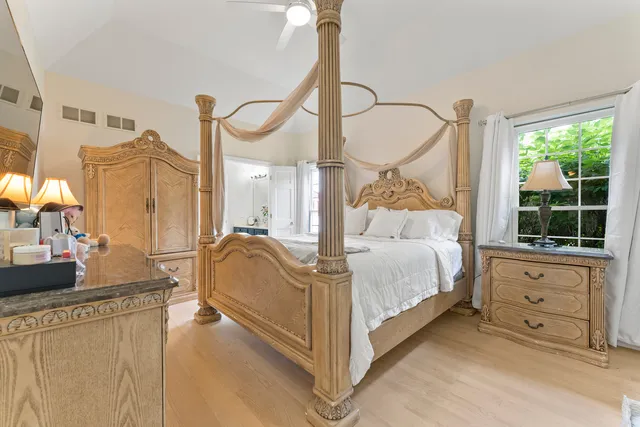 a bed room with a bed and a chandelier