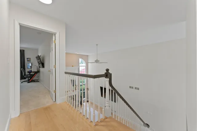 a bedroom with a bed gym equipment and a large window