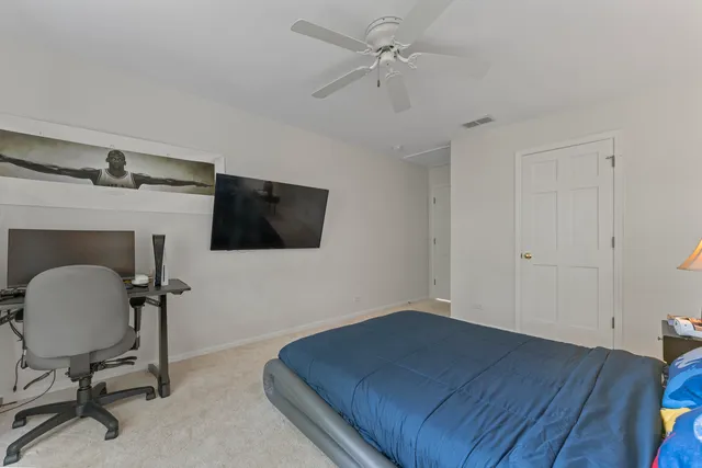 a bedroom with a large bed and a window