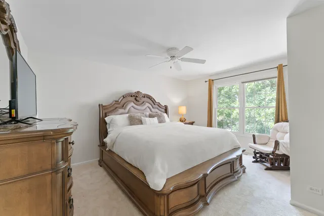 a bedroom with a bed and a chair