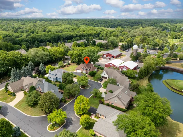 an aerial view of a house with swimming pool and lake view