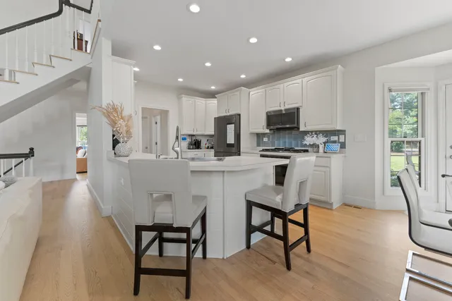 a kitchen with white cabinets and stainless steel appliances