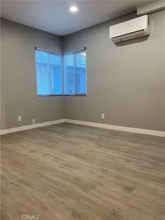 a view of a room with wooden floor