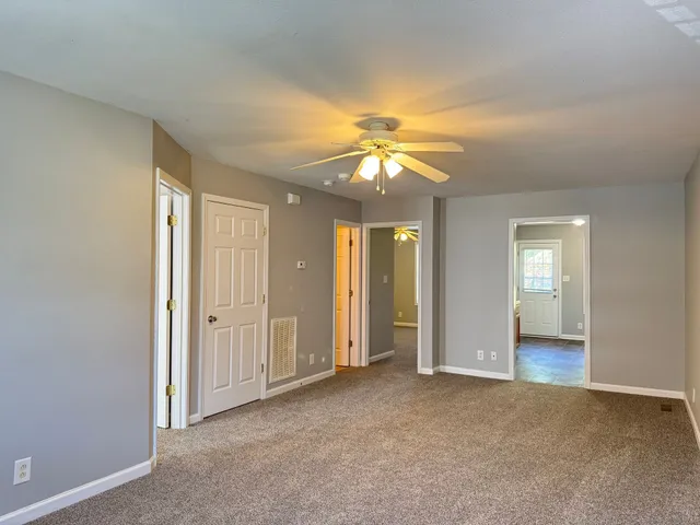 an empty room with a bathroom and a sink